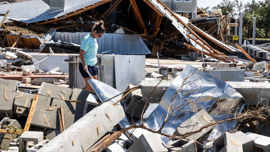 workers searches through rubble in Florida after Helene